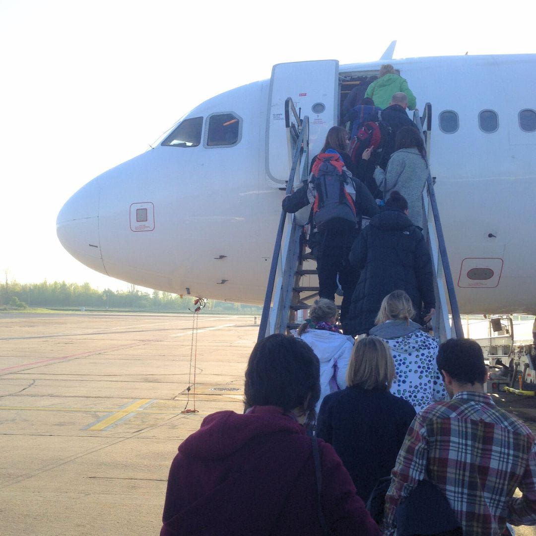 Passengers boarding a charter aircraft for an urgent emergency go-now evacuation flight.